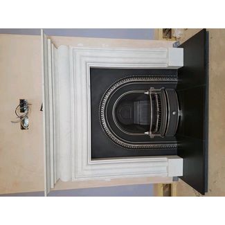 Limestone fireplace and cast iron highlighted arched insert