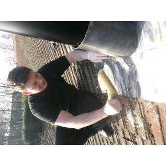 Lead flashing being dressed around the tiles for a twin wall flue system