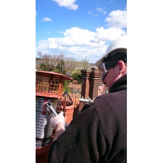 Pot hanger cowl being fixed onto the flexible flue liner