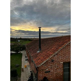 Black tw pro twin wall flue system through the clay pantiled roof on a barn conversion