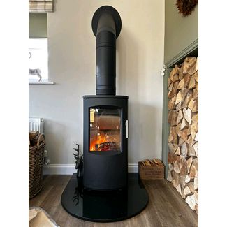 Heta 7B woodburner 4kw on a semi circle black polished granite hearth and twin wall flue
