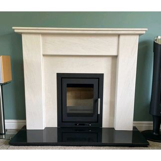 Heta Inspire 40 insert woodburner in black flat floor model 5kw with a Portuguese limestone Avelar mantel