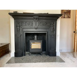 Hunter Herald 5 woodburner in a cast iron mantel